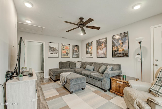 living room with ceiling fan and light hardwood / wood-style flooring