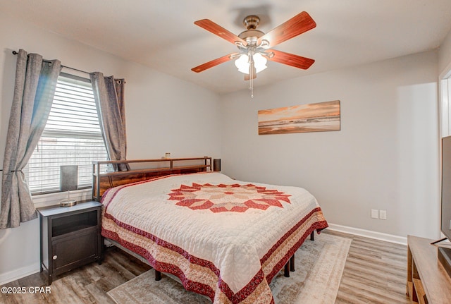 bedroom featuring ceiling fan and light wood-type flooring