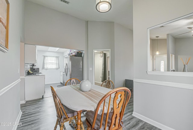 dining room featuring dark wood-type flooring and lofted ceiling