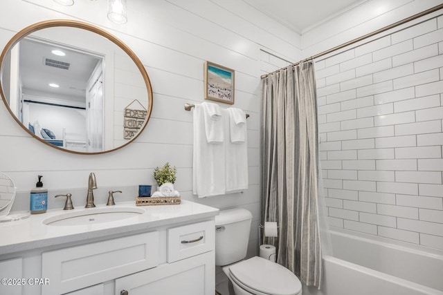 full bathroom featuring vanity, shower / tub combo with curtain, and toilet