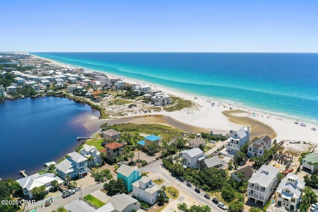 drone / aerial view featuring a water view and a view of the beach