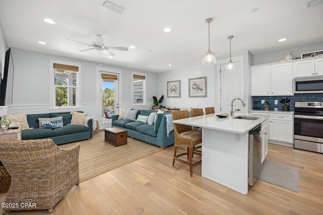 4923 E County Highway 30a Unit F103, Santa Rosa Beach, FL 32459 - kitchen with visible vents, a sink, stainless steel appliances, white cabinetry, and open floor plan