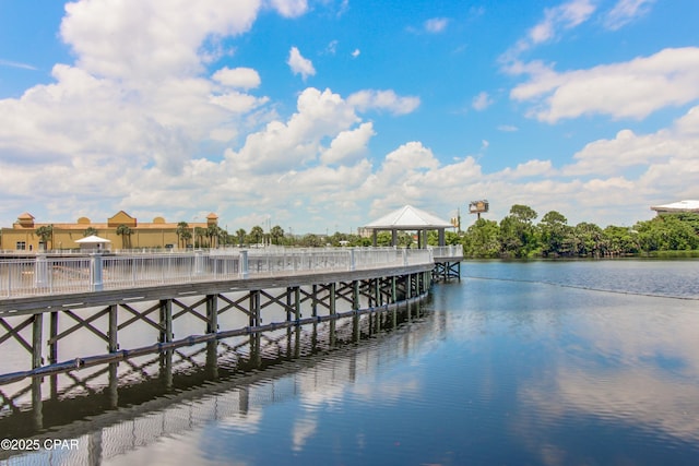 view of dock with a pier, a gazebo, and a water view