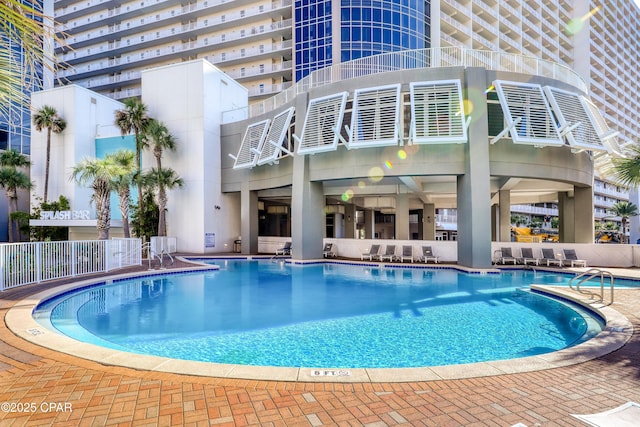 pool featuring a patio and fence