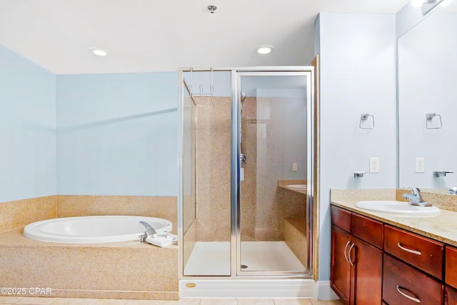 bathroom featuring a garden tub, a stall shower, and vanity