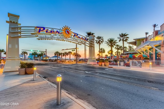 view of road featuring curbs, traffic lights, and sidewalks