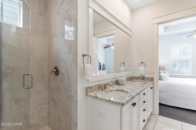 bathroom featuring vanity, a healthy amount of sunlight, ceiling fan, and a shower with shower door