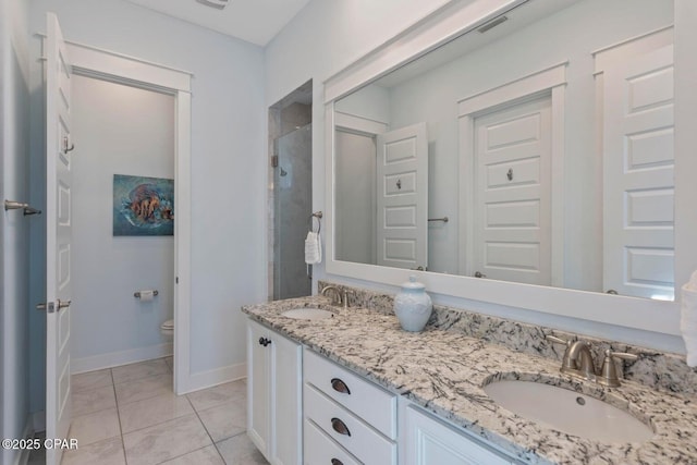 bathroom featuring tile patterned flooring, vanity, toilet, and an enclosed shower