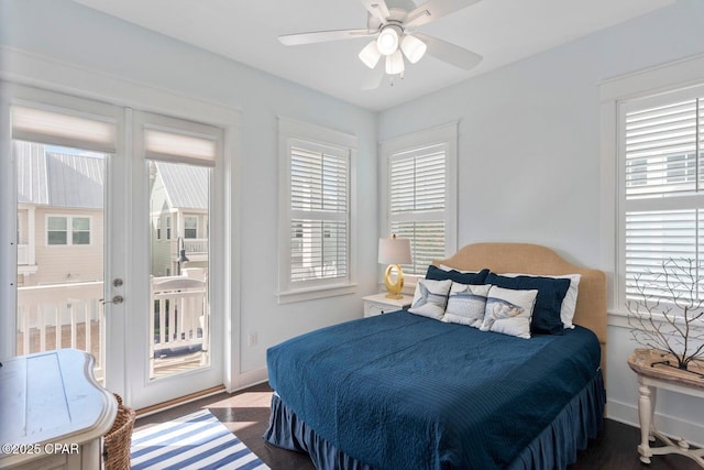 bedroom with dark hardwood / wood-style floors, ceiling fan, and access to exterior