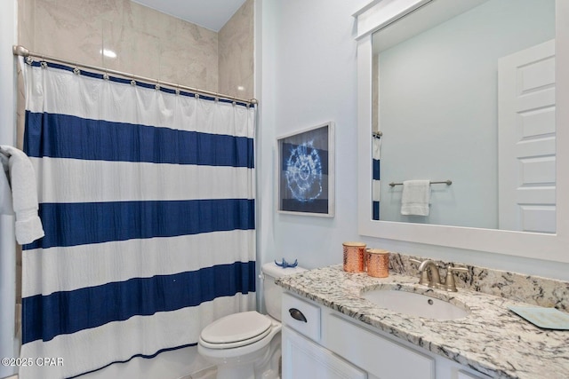 bathroom with vanity, toilet, and walk in shower