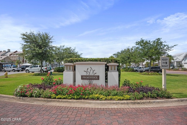 community sign featuring a lawn