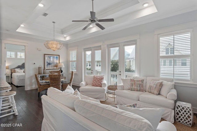 living room featuring crown molding, ceiling fan, dark hardwood / wood-style floors, french doors, and a raised ceiling