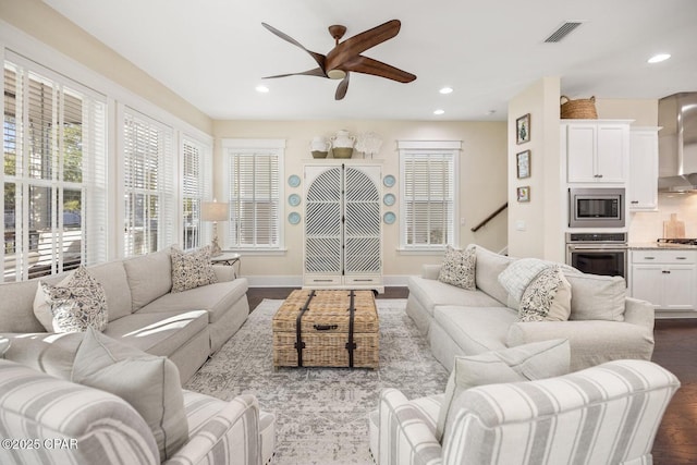 living room featuring hardwood / wood-style floors and ceiling fan