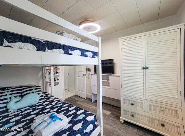 bedroom with dark wood-type flooring