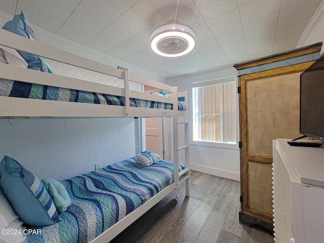 bedroom featuring baseboards and wood finished floors