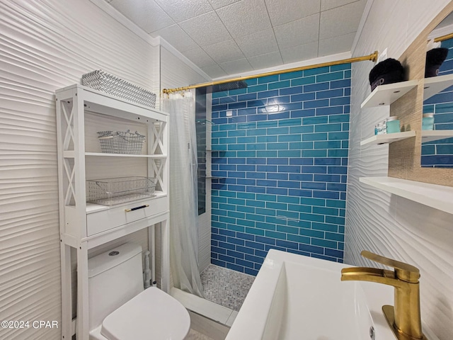 full bathroom featuring a stall shower, toilet, and crown molding