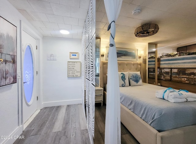 bedroom featuring wood finished floors and baseboards