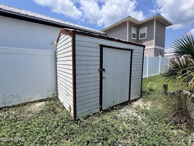 view of shed with fence