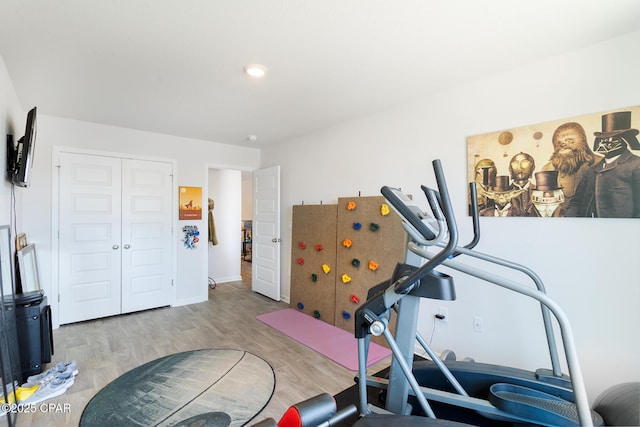 exercise area with light wood-type flooring
