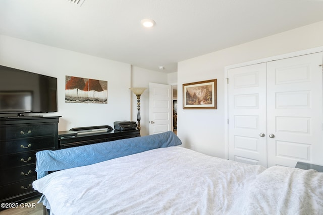 bedroom with hardwood / wood-style flooring and a closet