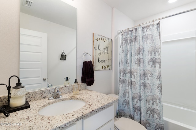 full bathroom featuring shower / bath combination with curtain, vanity, and toilet