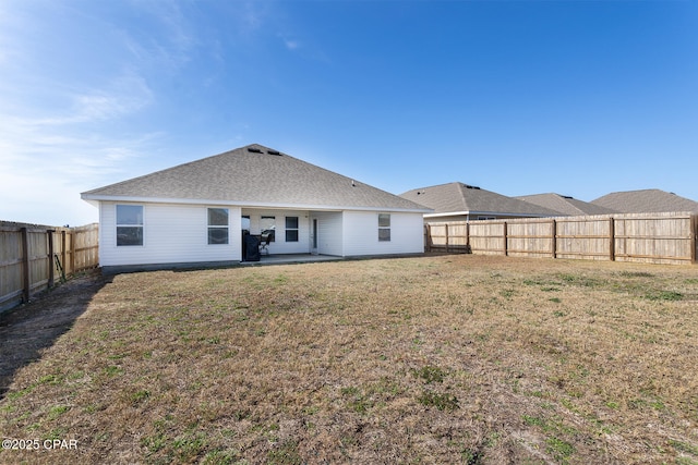 back of house with a patio area and a lawn