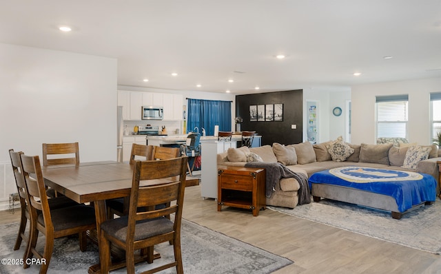 dining area with light hardwood / wood-style floors