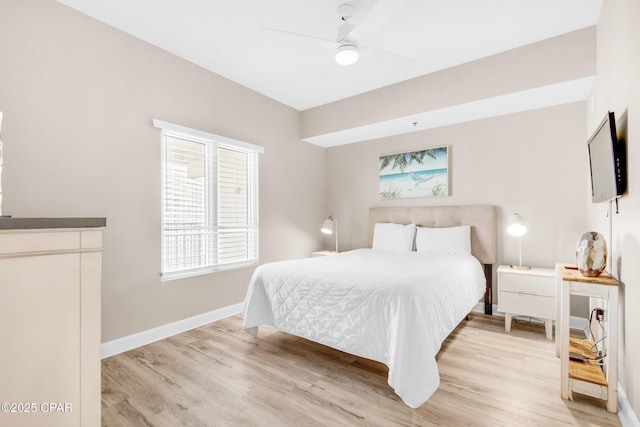 bedroom with ceiling fan, light wood finished floors, and baseboards