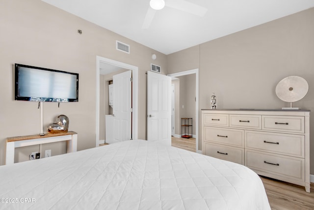 bedroom with baseboards, a ceiling fan, visible vents, and light wood-style floors