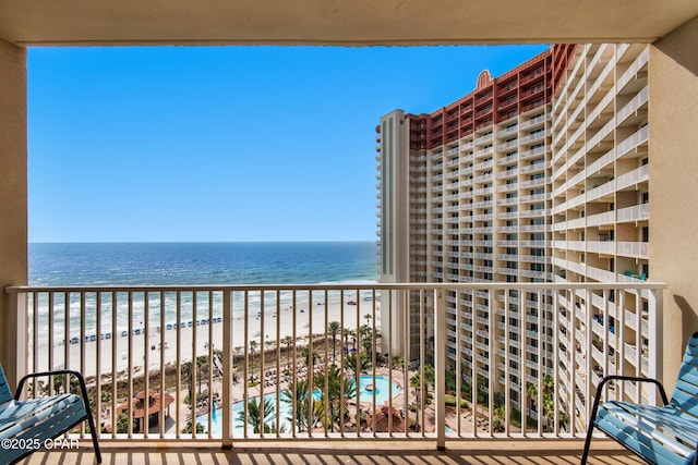 balcony featuring a water view and a view of the beach