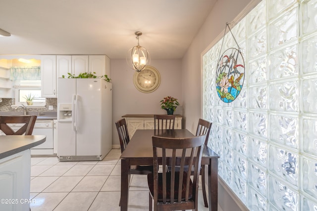 dining room featuring sink and light tile patterned floors