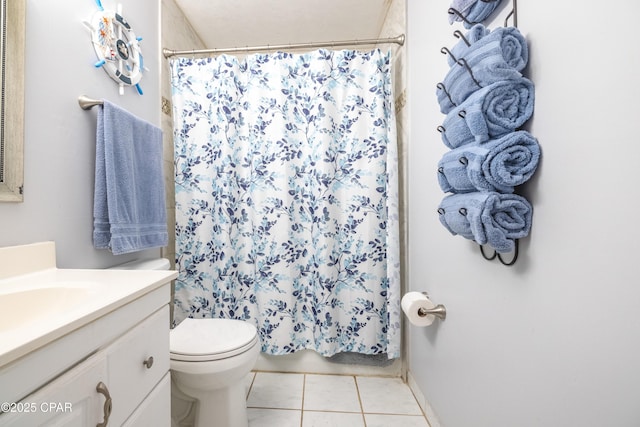 bathroom with vanity, curtained shower, tile patterned floors, and toilet