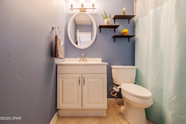 bathroom featuring vanity, toilet, and tile patterned flooring