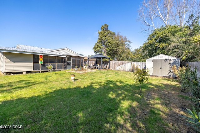 view of yard featuring a gazebo, a sunroom, and a storage unit