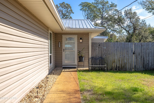 property entrance with a lawn