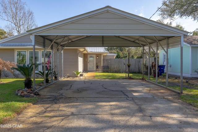 view of car parking featuring a carport and a yard