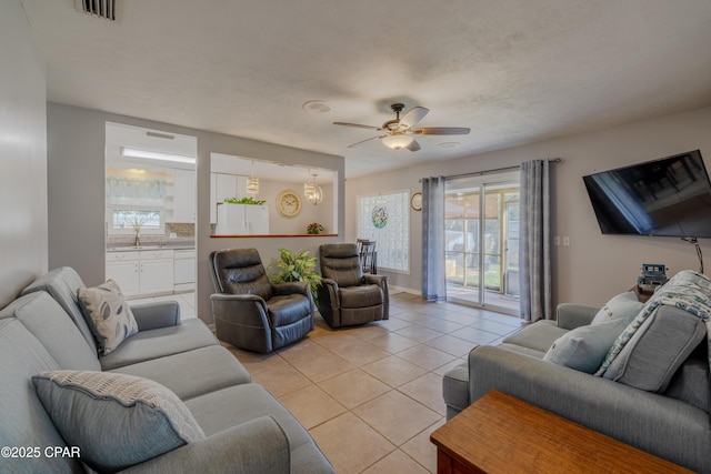 living room with ceiling fan and light tile patterned floors