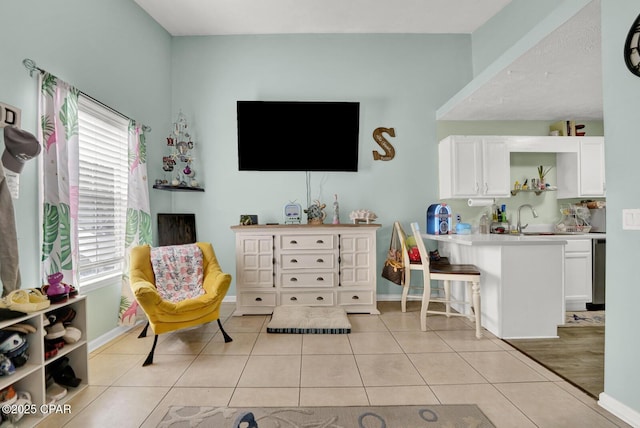 sitting room with sink and light tile patterned floors