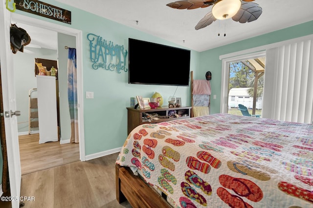 bedroom with wood-type flooring, ceiling fan, and access to outside