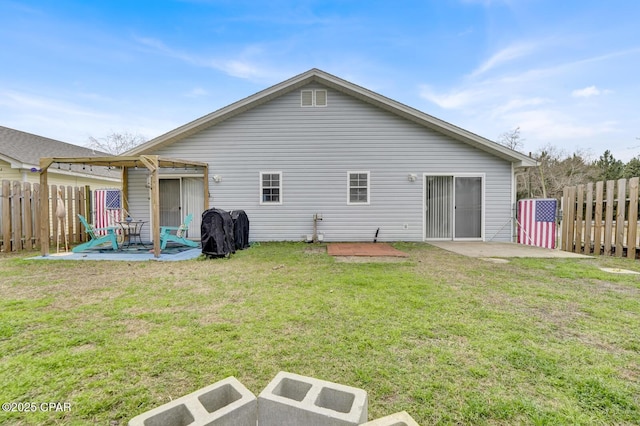 back of house featuring a yard, a pergola, and a patio