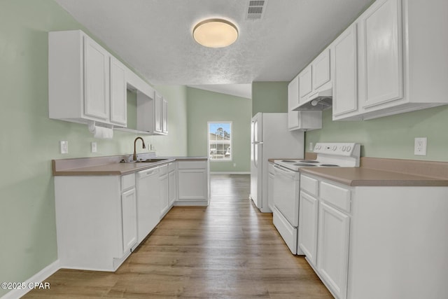 kitchen with sink, white appliances, light hardwood / wood-style flooring, a textured ceiling, and white cabinets