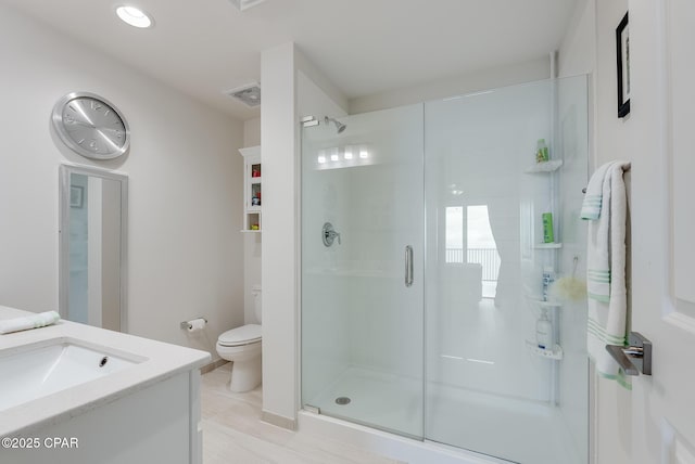 bathroom with vanity, toilet, and walk in shower