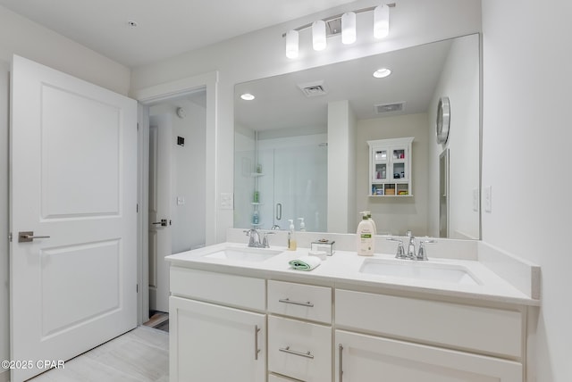 bathroom with vanity and an enclosed shower