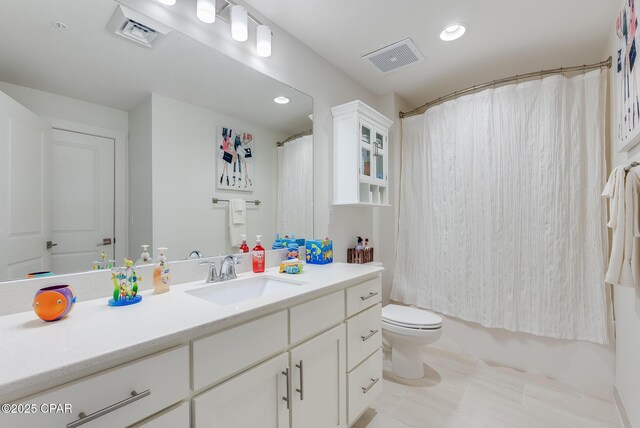 full bathroom with vanity, shower / bathtub combination with curtain, and toilet