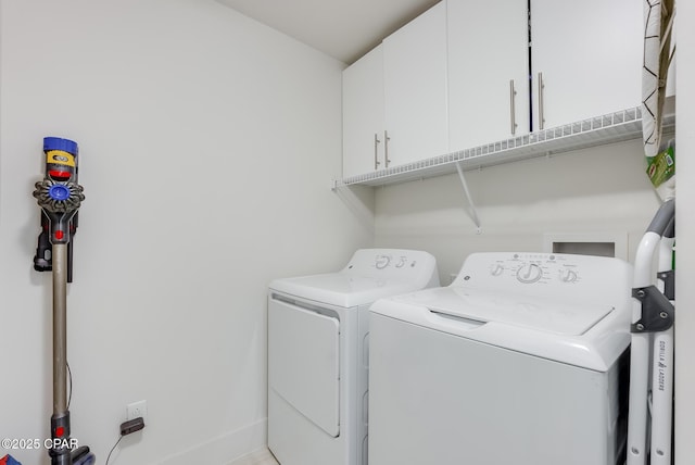 laundry room featuring cabinets and separate washer and dryer