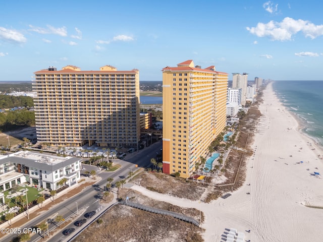 aerial view with a water view and a beach view