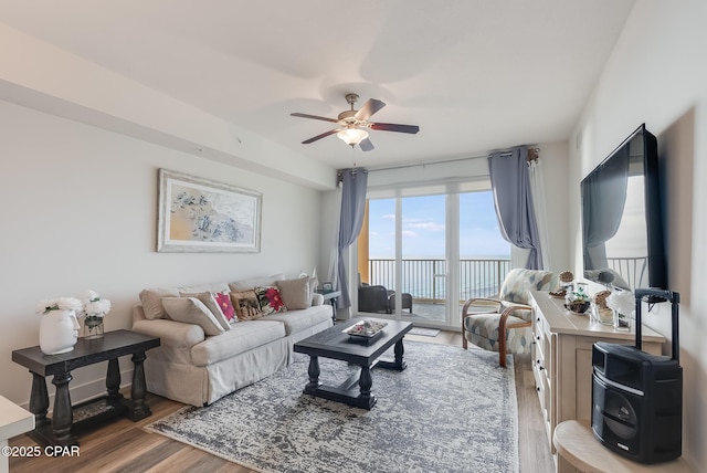 living room featuring hardwood / wood-style flooring and ceiling fan