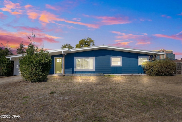 ranch-style house featuring a yard