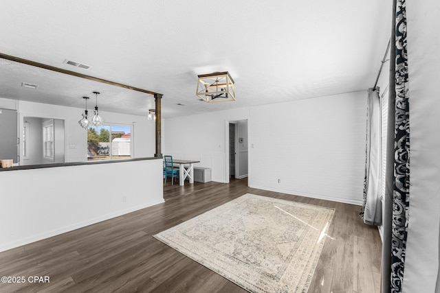 interior space featuring dark hardwood / wood-style floors and a textured ceiling