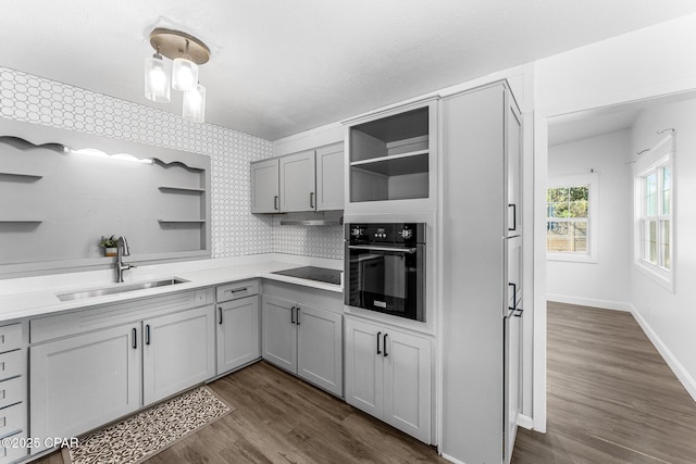 kitchen featuring gray cabinetry, dark hardwood / wood-style floors, sink, and black appliances